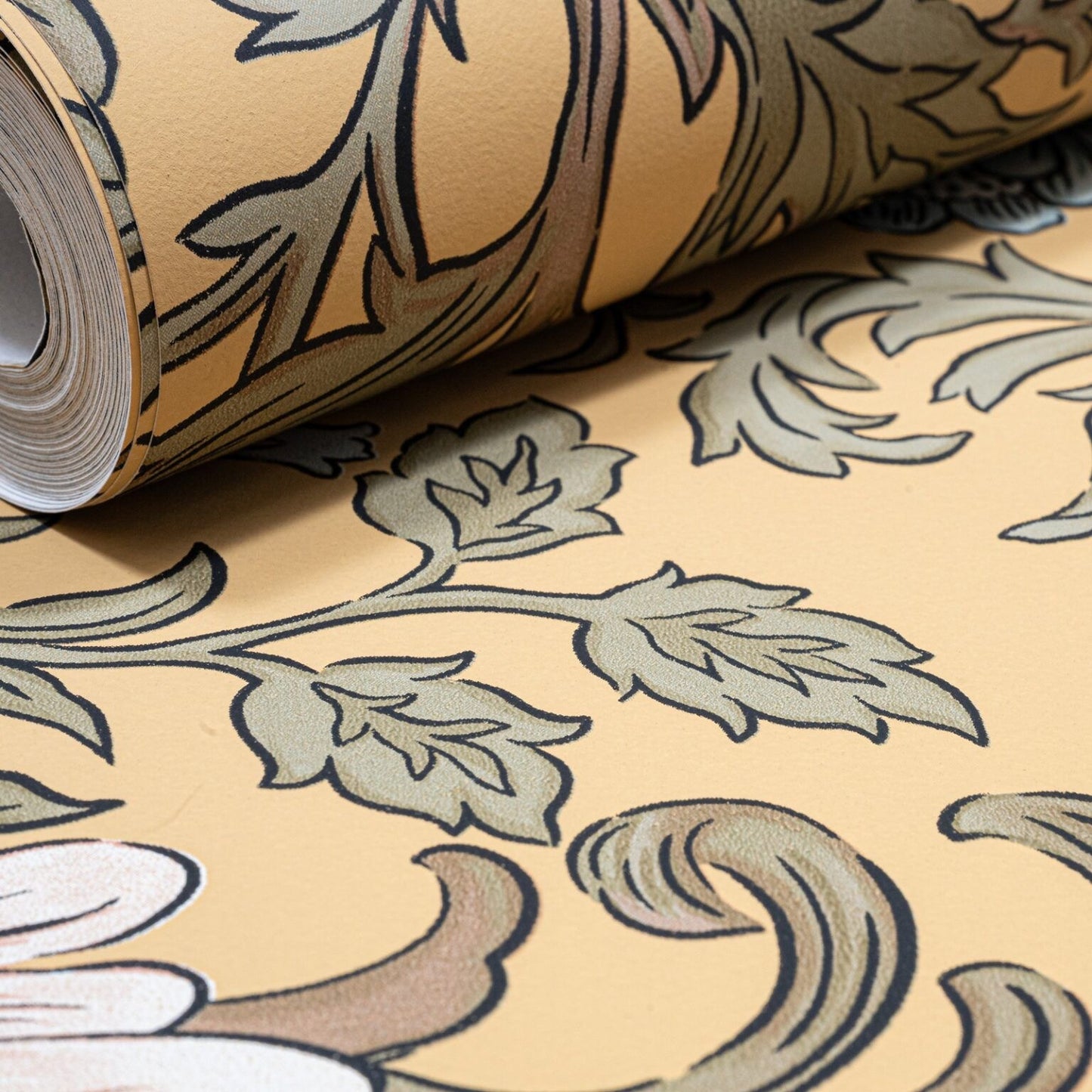 Mustard Floral Wallpaper roll close up showing scrolling leaf and floral detail