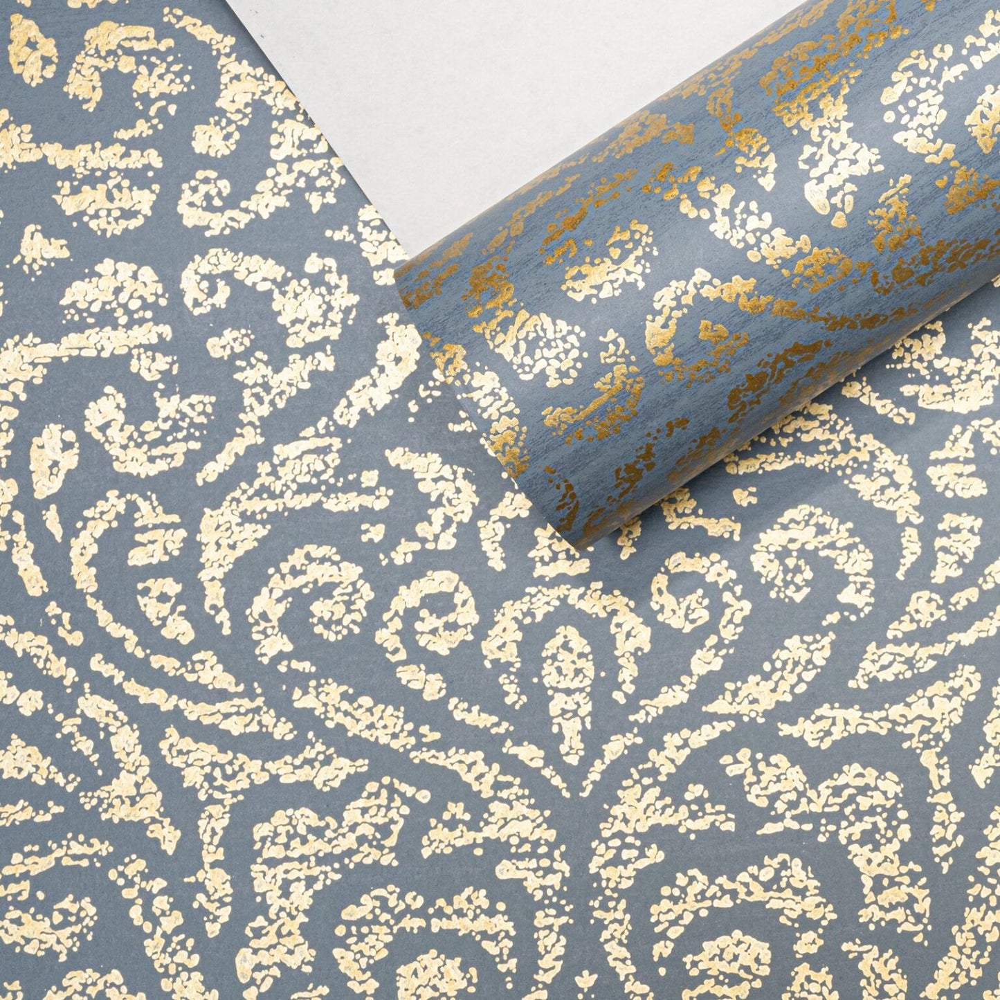 Blue Floral Damask Gold Metallic Shimmer Wallpaper roll close up showing scrolling gold pattern