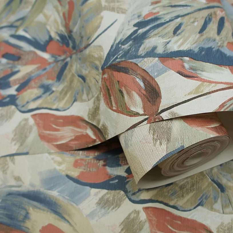 Aralia Leaf Wallpaper roll close up showing painterly leaf detail in rust green and blue tones