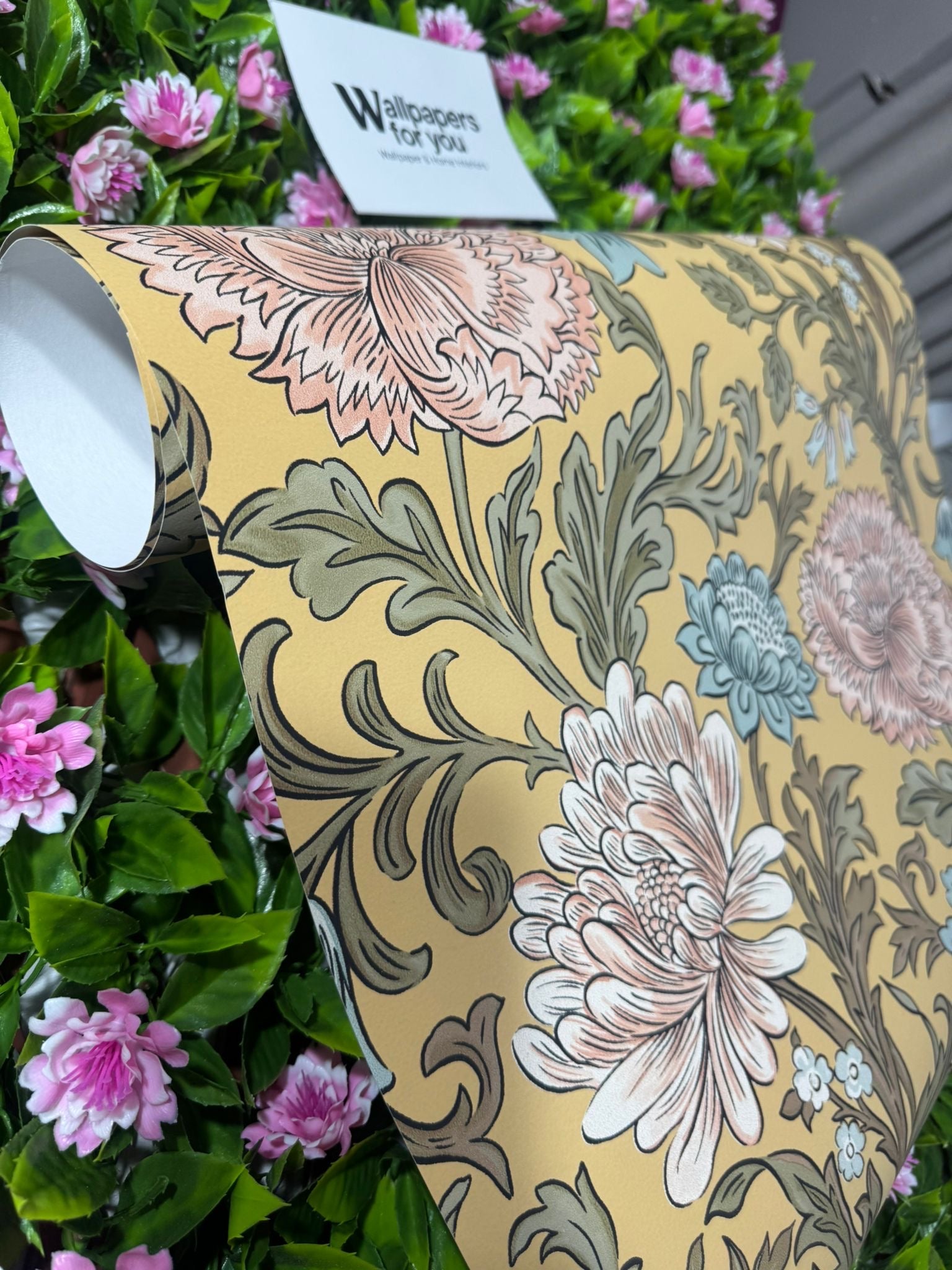 Mustard Floral Wallpaper roll with Wallpapers For You branding amongst pink garden flowers