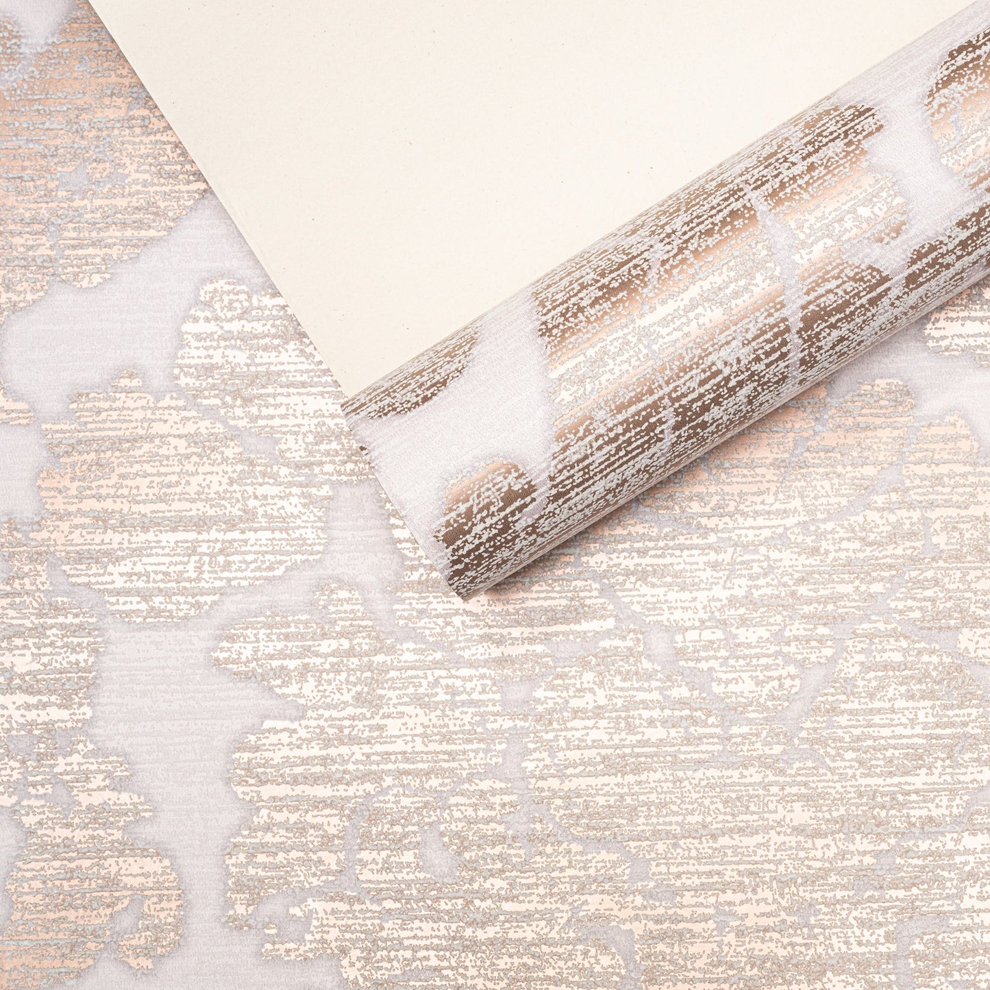 Rose Gold Damask Wallpaper roll with sample showing pattern scale and metallic sheen