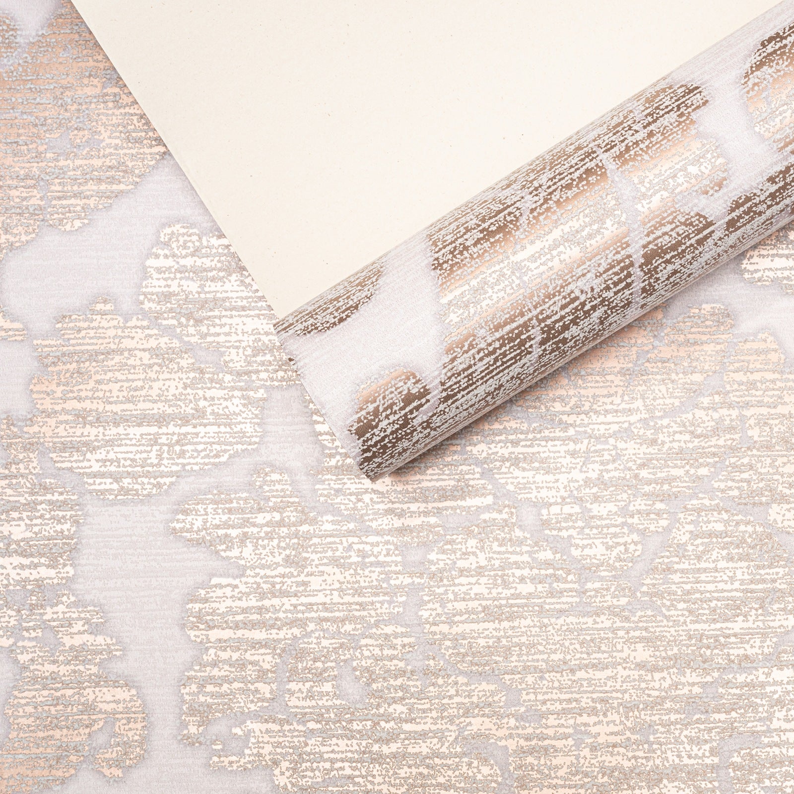 Rose Gold Damask Wallpaper roll with sample showing pattern scale and metallic sheen