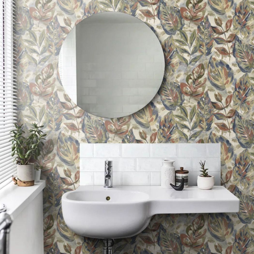Aralia Leaf Wallpaper in modern bathroom with round mirror and white basin